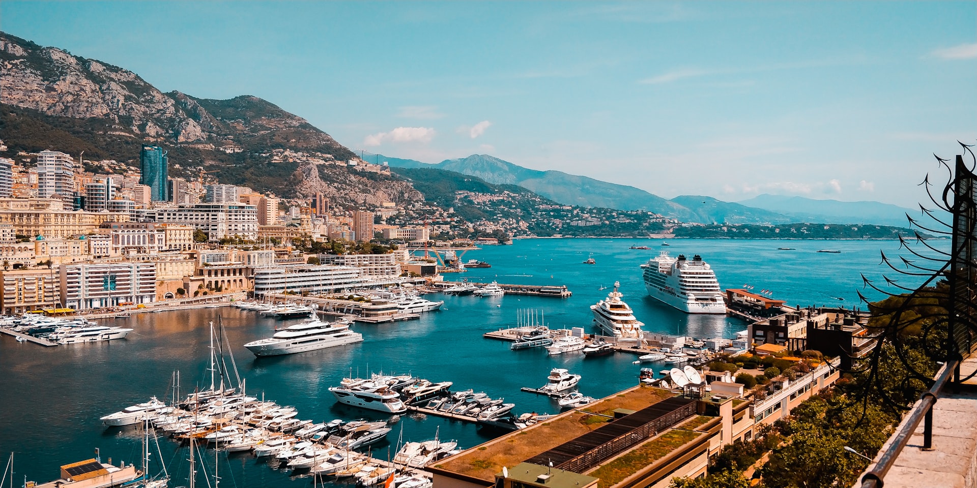 A harbor filled with yachts and a cruise ship in Monaco