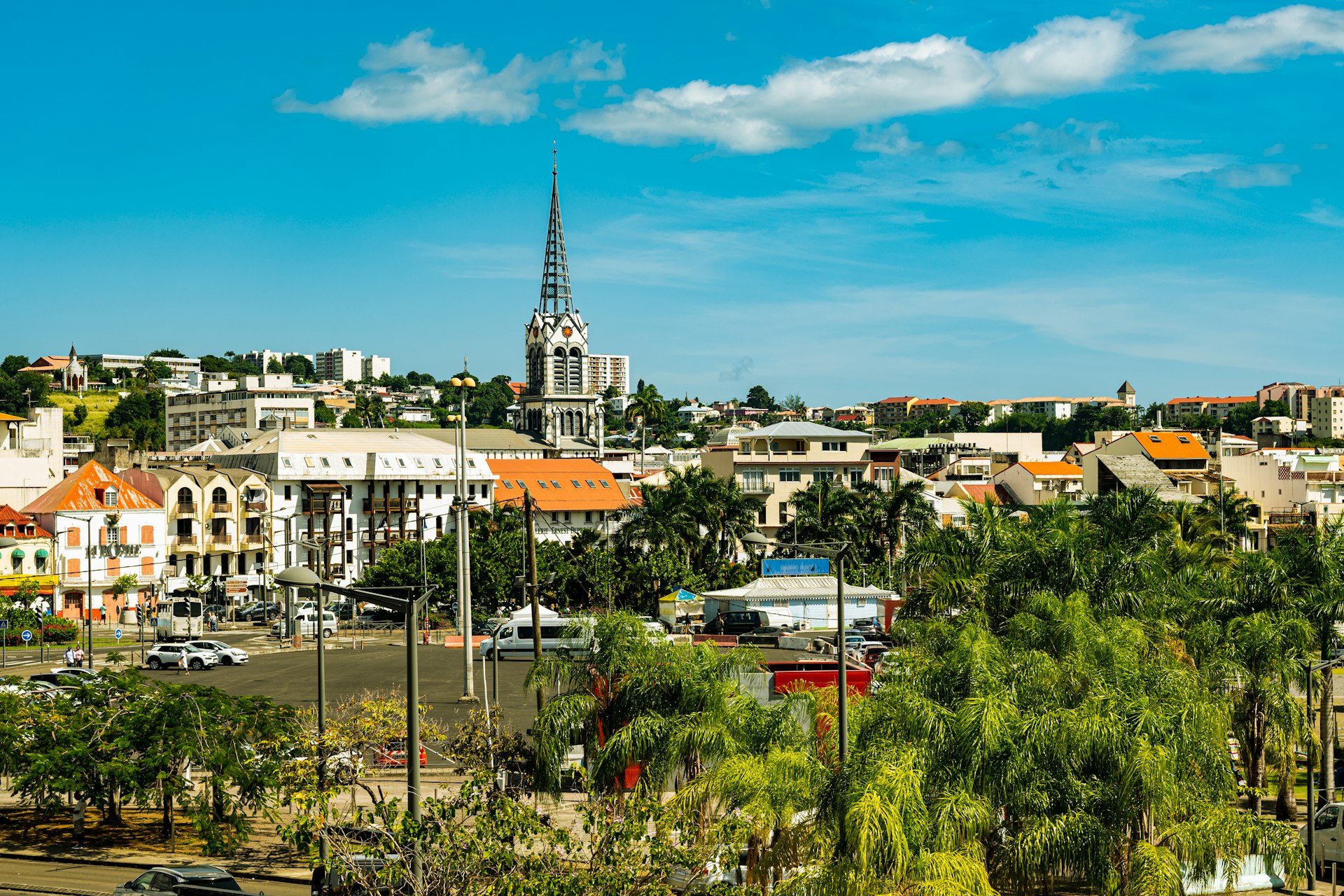 a view of a city with a church steeple in the background